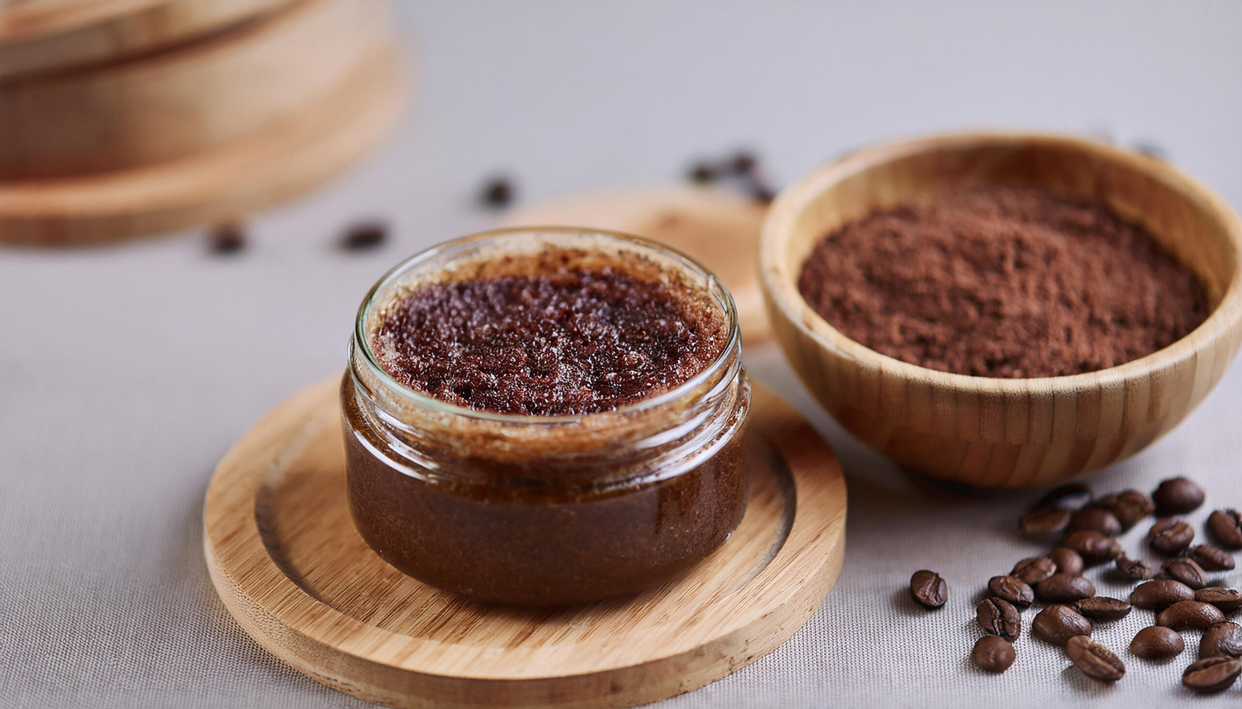 Coffee body scrub in glass jar with coffee beans. Beauty and skin care concept. Organic cosmetic. Coffee body scrub in glass jar with coffee beans. Beauty and skin care concept. Organic cosmetic. Close-up.